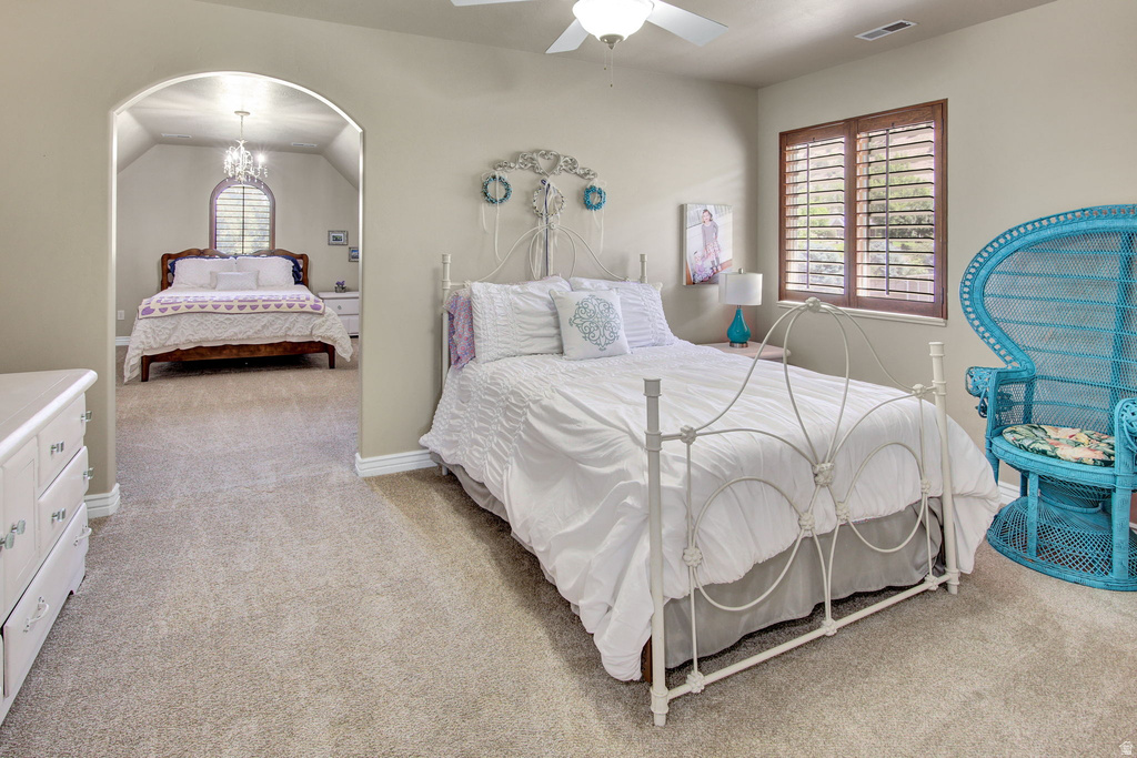 Carpeted interior space featuring an arched entryway, recessed lighting, and a ceiling fan