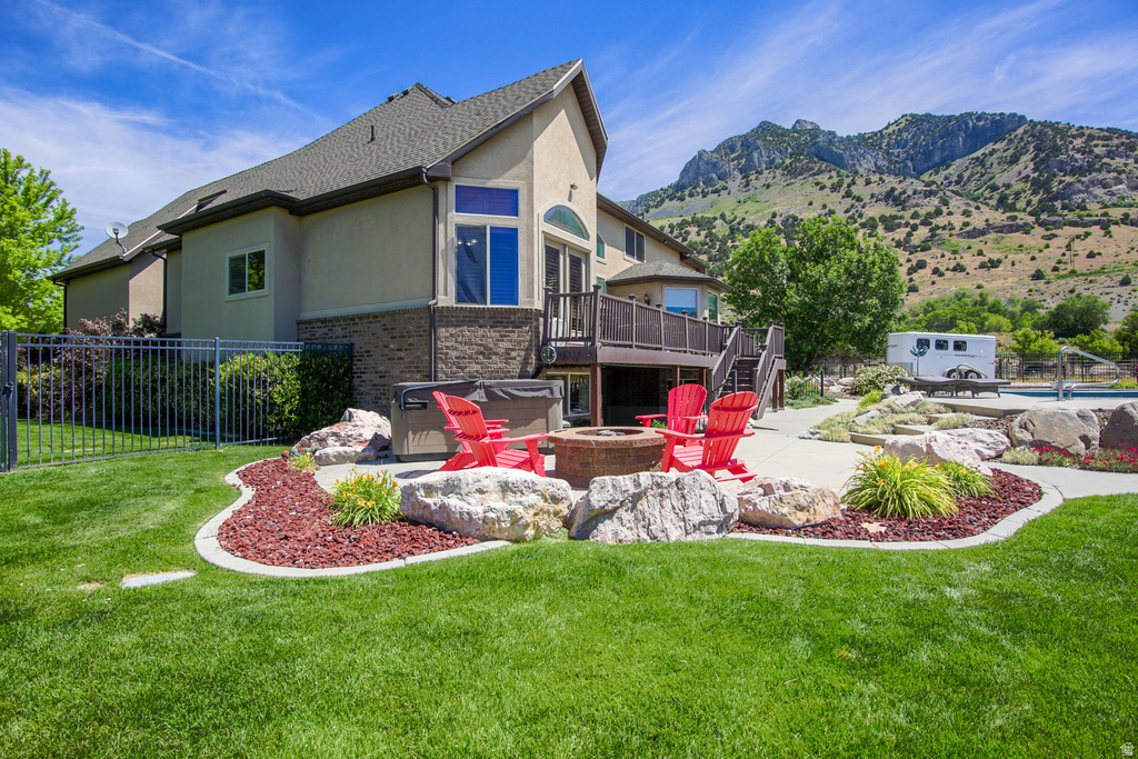 Expansive rear exterior featuring a multi-level deck, a built-in fire pit, and a swimming pool