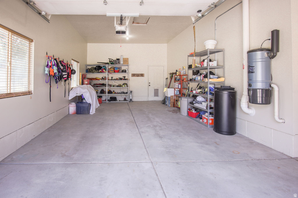 Spacious garage featuring concrete flooring and a high ceiling