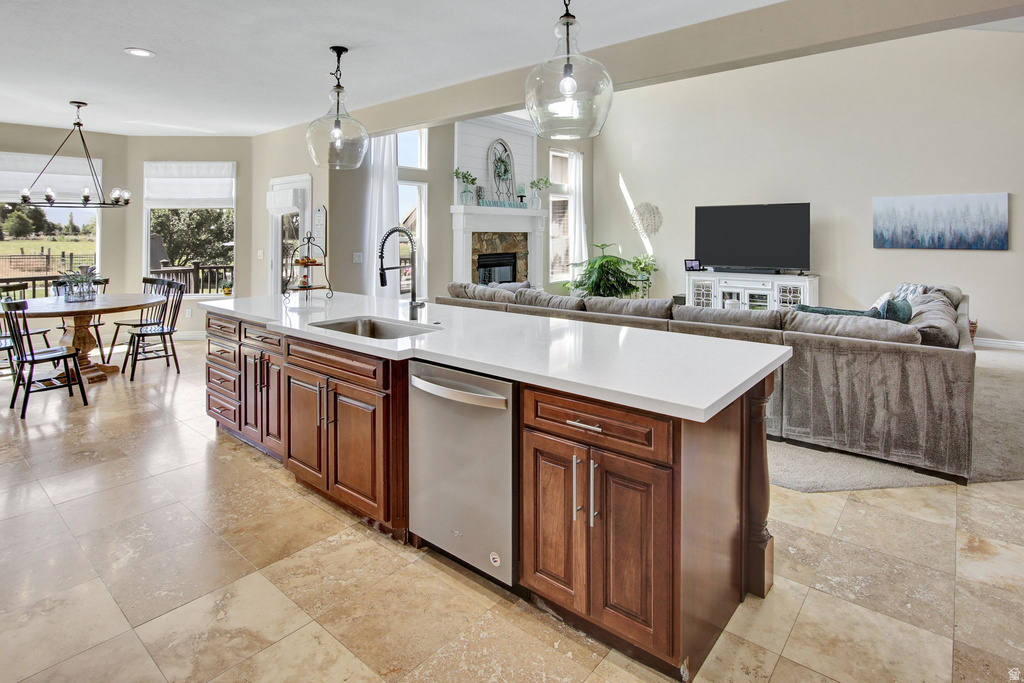 Kitchen island with an undermount sink, gooseneck faucet, and stainless steel dishwasher