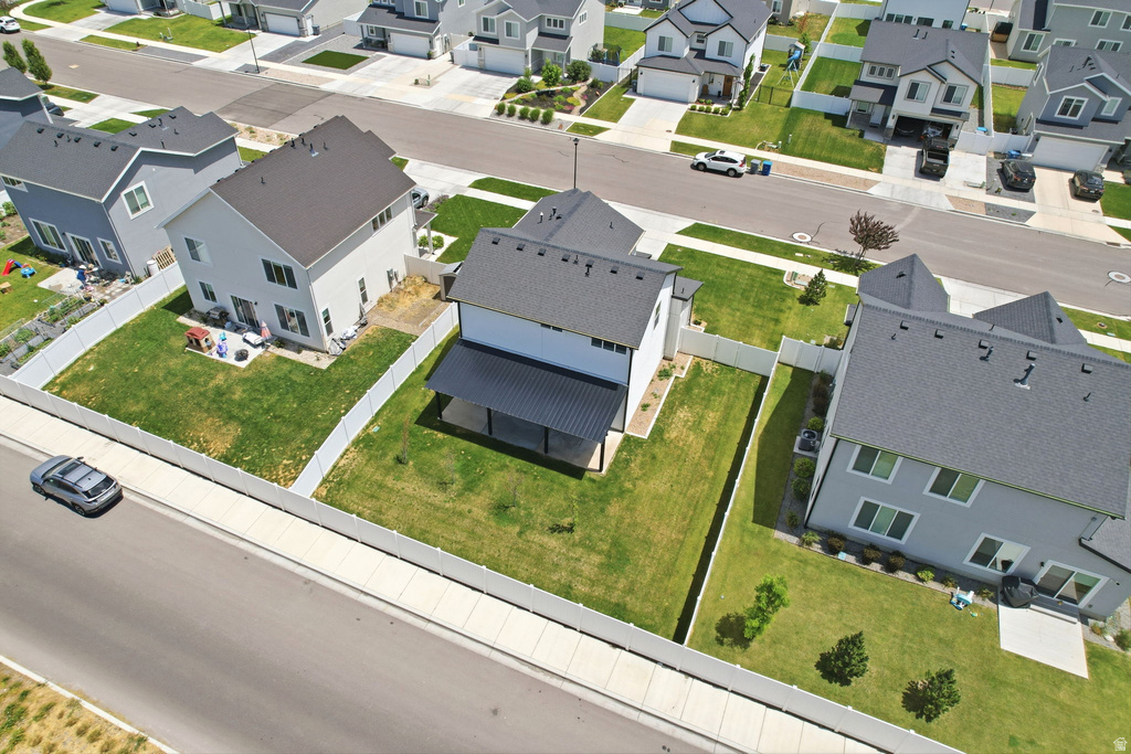 Contemporary two-story residence featuring a dark gray asphalt shingle roof and light-colored siding