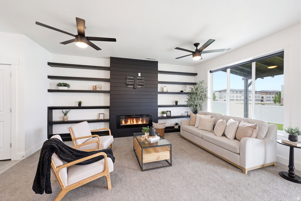 Living area featuring a floor-to-ceiling fireplace with a linear insert, flanked by integrated shelving