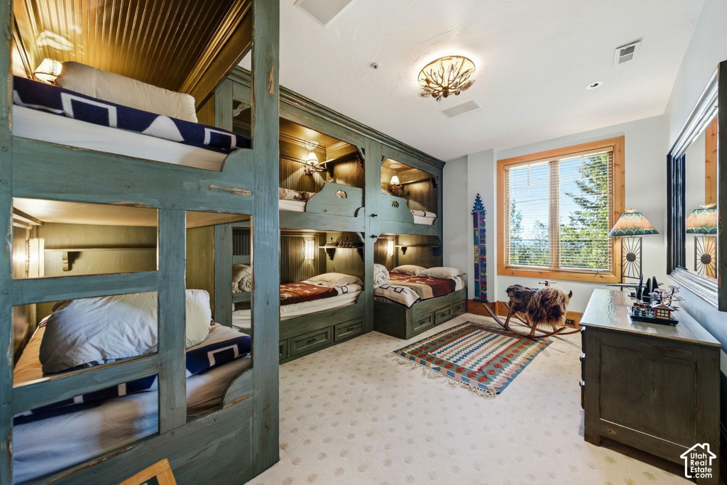 Custom built-in bunk beds with individual lighting fixtures and integrated storage drawers