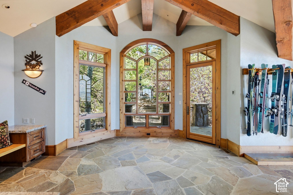 Vaulted ceilings with exposed timber beams complement the irregular flagstone flooring