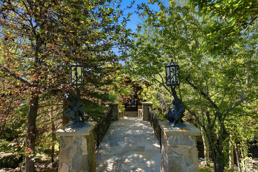 Stone pathway featuring decorative iron railings