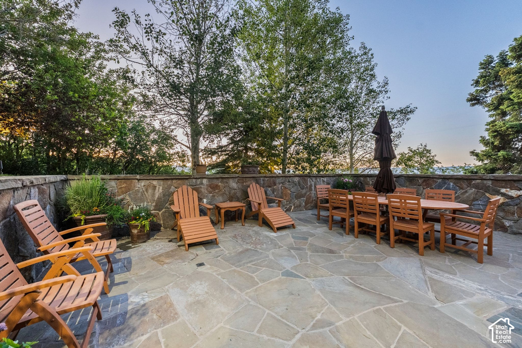 Expansive flagstone patio with a natural stone retaining wall