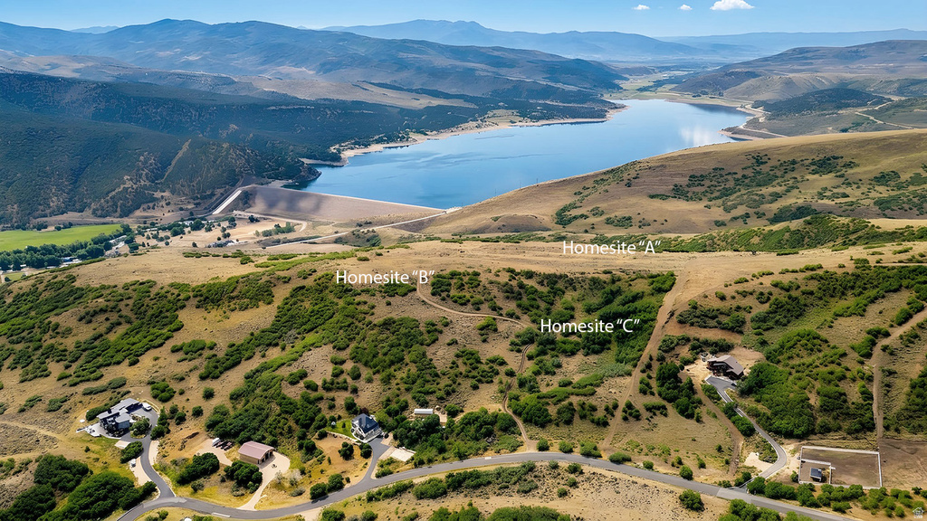 Homesites A, B, and C situated on a hillside overlooking a substantial body of water and distant mountains