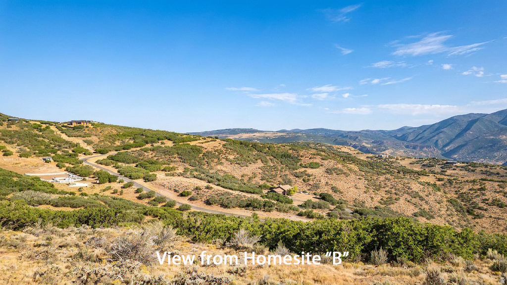 Expansive mountain landscape with rolling hills and abundant natural foliage