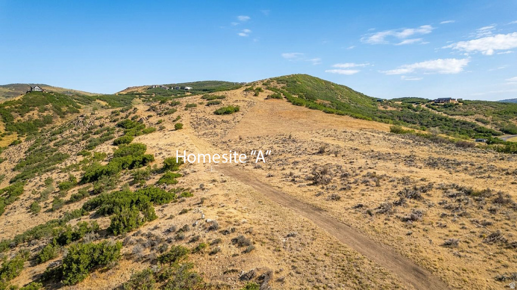 Expansive undeveloped terrain featuring varied topography and distant structures