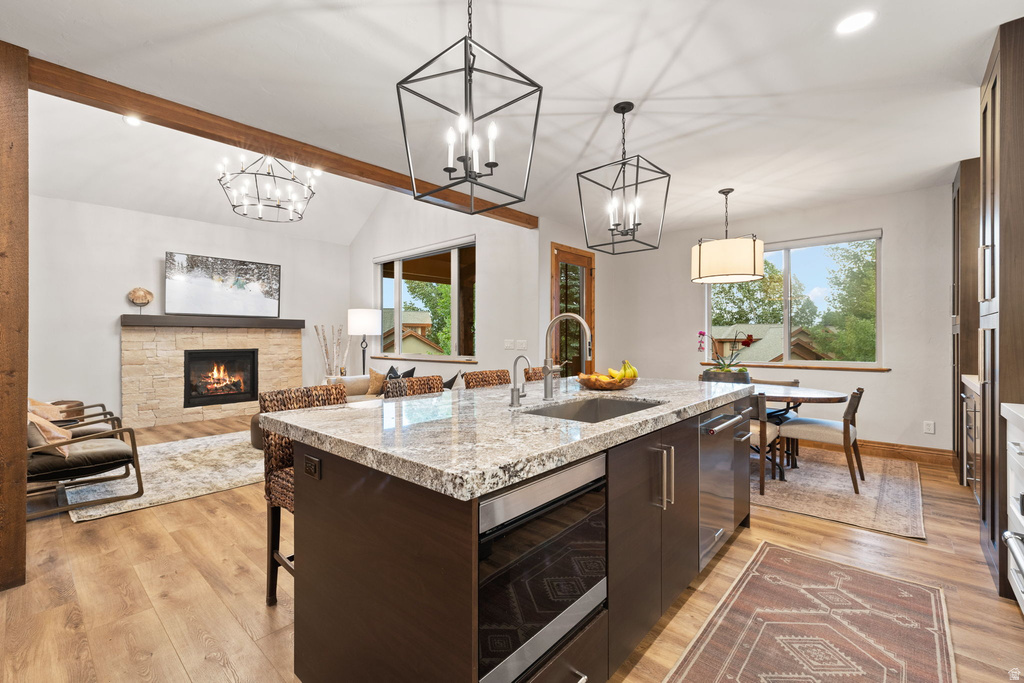 Kitchen island with a granite-style countertop, undermount sink, and integrated microwave