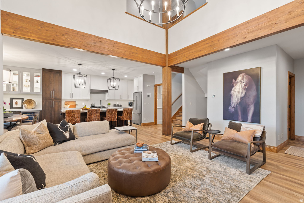 Vaulted ceilings with exposed wood beams define this open-concept living area