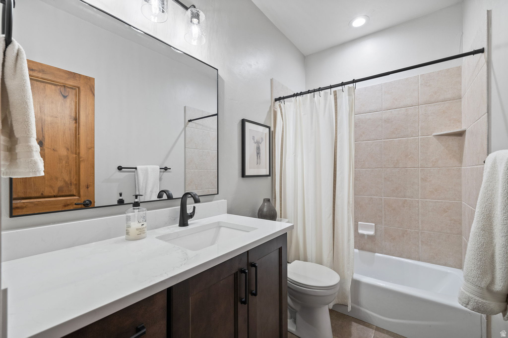 Bathroom featuring a vanity with dark wood-finish cabinetry, white countertop, and integrated sink