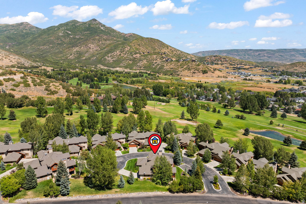 Aerial perspective showcasing a residential community nestled against a mountainous backdrop