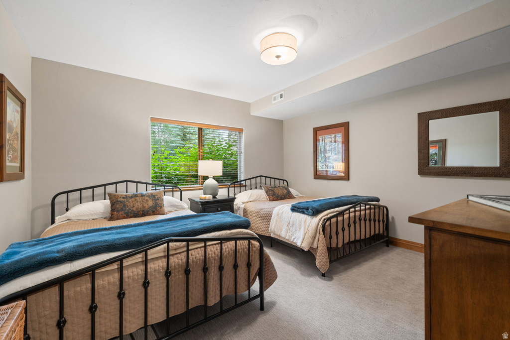 Window-equipped room featuring light gray walls and plush carpet flooring