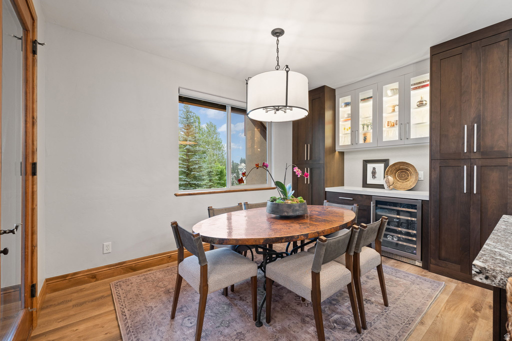 Dining area featuring wood-finish flooring and a built-in beverage center