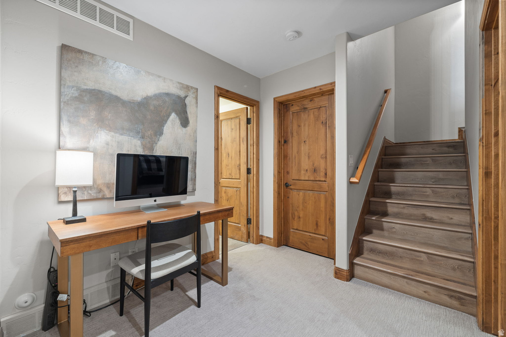 Carpeted landing with wood-finish flooring on the staircase