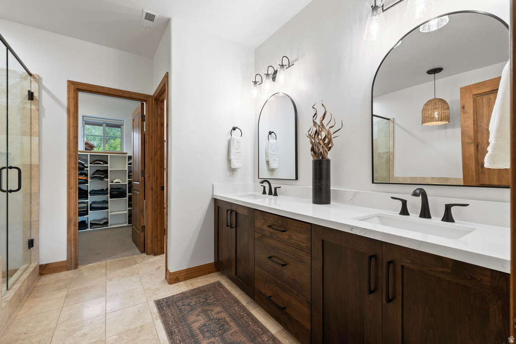 Dual vanity with quartz countertops, undermount sinks, and matte black fixtures