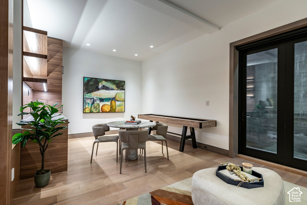 Recessed lighting illuminates wood-finish flooring