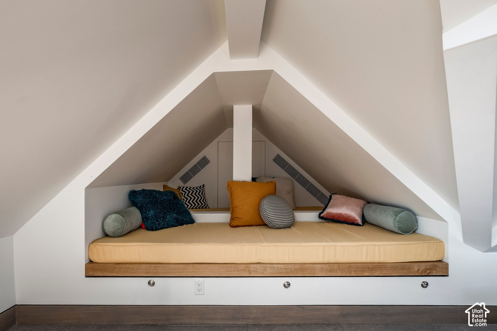 Built-in window seat with a natural wood-finish base, integrated lighting, and a neutral-toned cushion