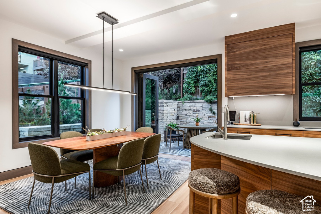Open-concept living space featuring a modern linear chandelier over the dining area