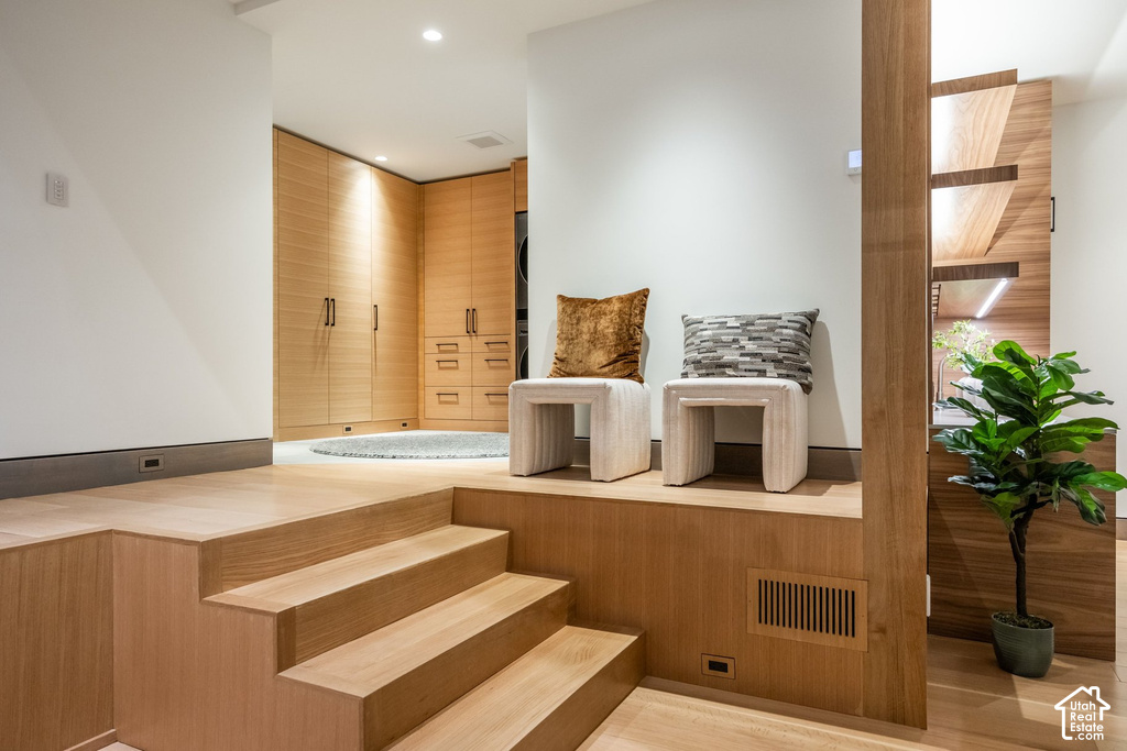 Multilevel wood-finish flooring featuring integrated steps and a built-in seating platform