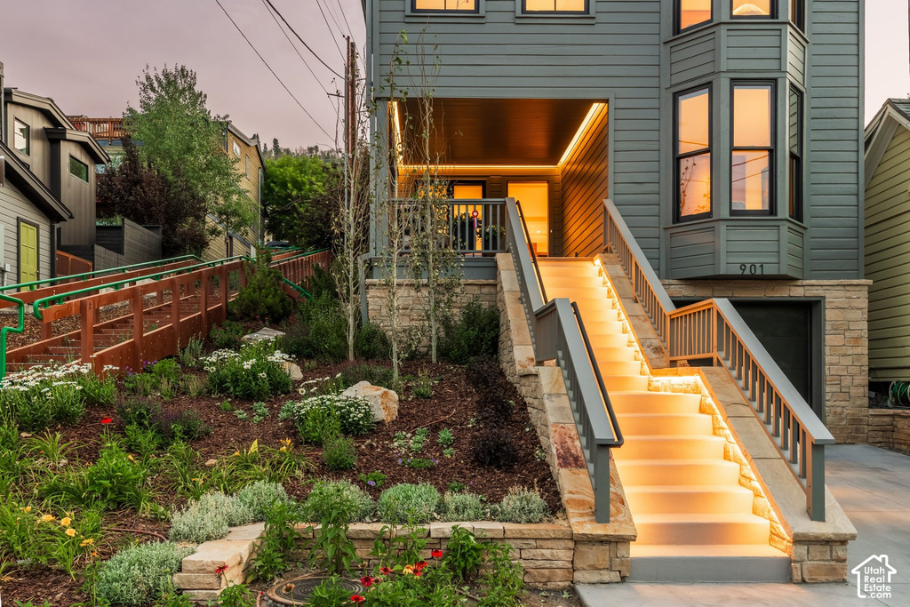 Exterior featuring horizontal plank siding, a stone base, and a bay window