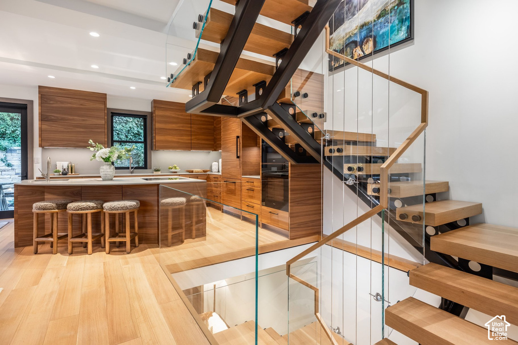 Floating staircase featuring glass railings and wood-finish treads