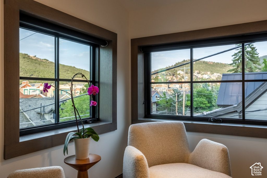 Corner window installation with dark trim, offering expansive natural scenery