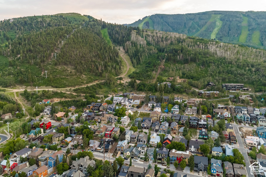 Expansive mountain landscape featuring a community of residences nestled into the foothills