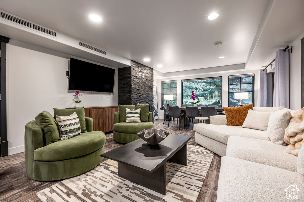 Open-concept living space with wood-finish flooring and recessed lighting