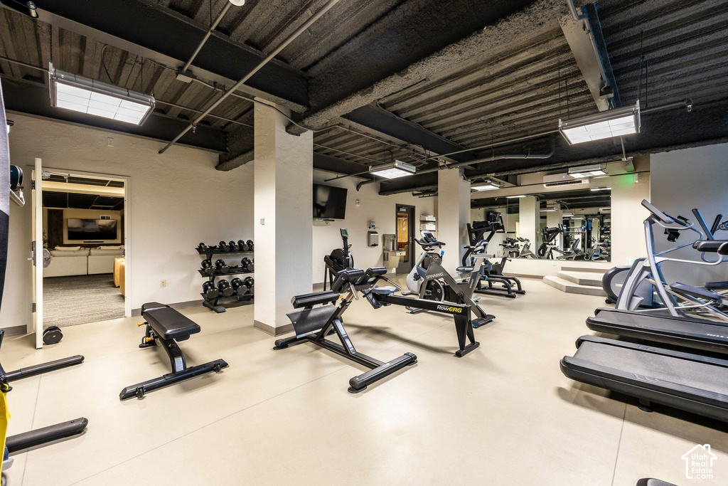 Fitness center featuring treadmills, exercise bikes, and free weights