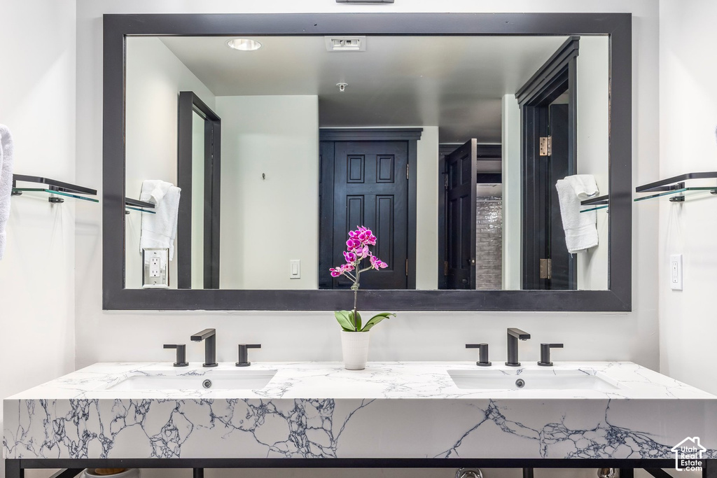 Double vanity with a white and gray veined countertop, two undermount sinks, and matte black fixtures