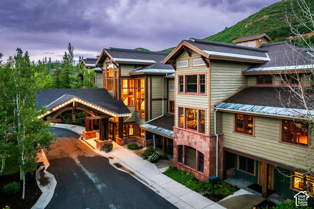 Multi-level building with extensive wood-finish siding and stone accents