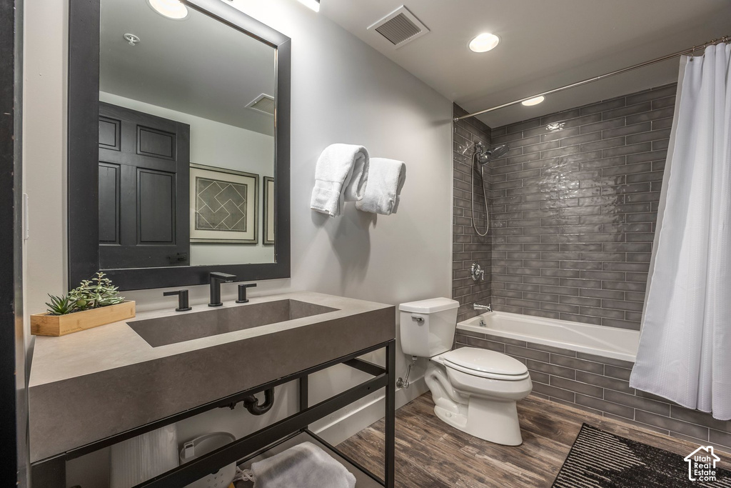 Bathroom featuring a floating vanity with an integrated sink, matte black faucet, and a large framed mirror