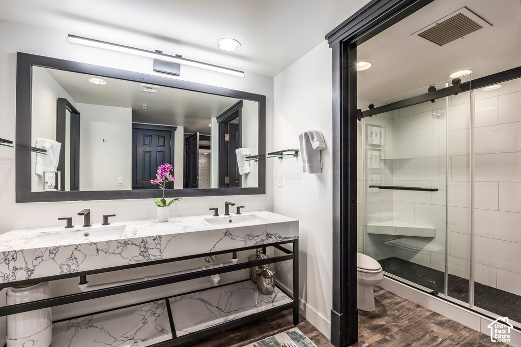 Double vanity featuring white marbled countertops and dual undermount sinks with matte black fixtures