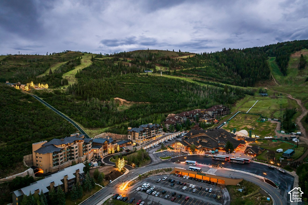 Hillside property featuring multiple multi-story buildings with varied rooflines and extensive parking areas