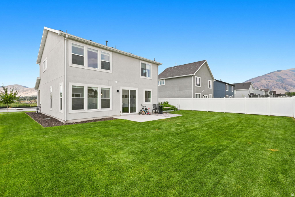 Expansive green lawn with a white vinyl fence