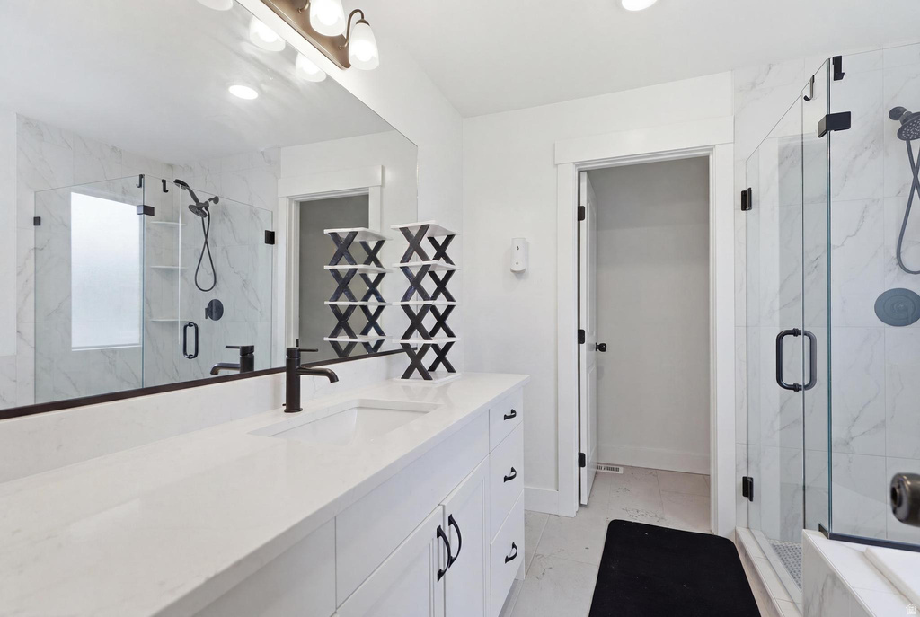Spacious bathroom featuring a white vanity with matte black hardware, a rectangular undermount sink, and a quartz countertop