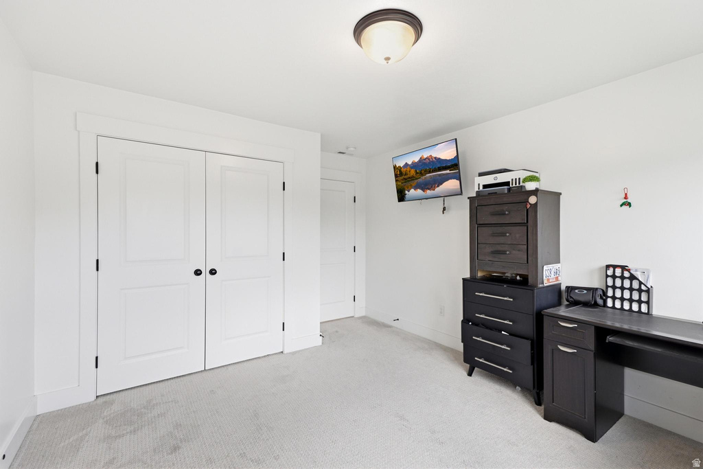 Light-toned wall-to-wall carpeting complements the bright white walls and trim