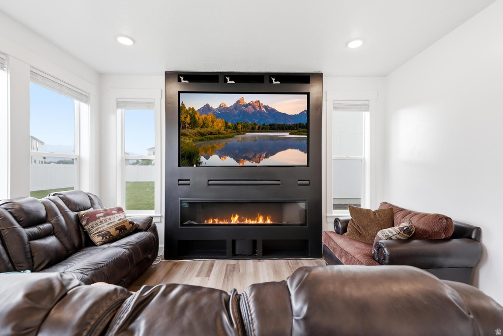Integrated entertainment wall with a linear electric fireplace, recessed television, and built-in shelving
