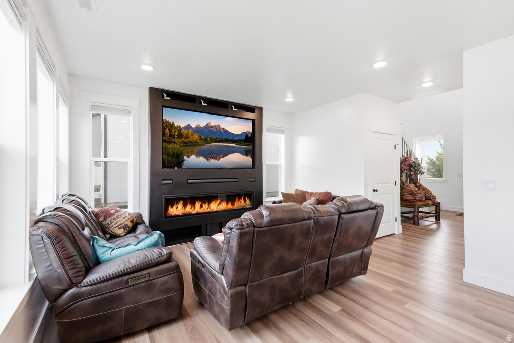 Living area featuring a built-in media center with an integrated linear fireplace
