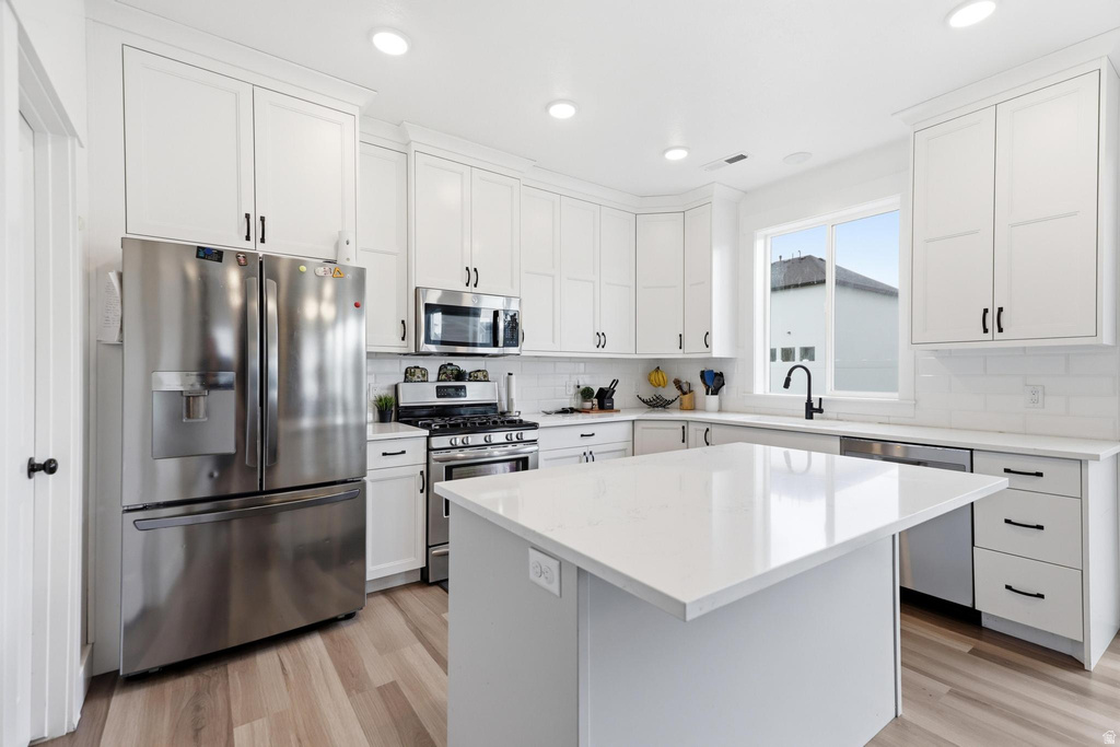 Bright kitchen featuring a central island with a white countertop