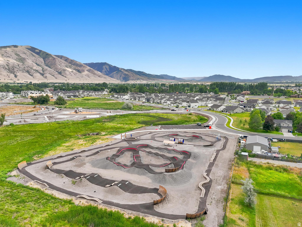 Aerial view showcasing a dedicated pump track facility featuring multiple asphalt and dirt tracks with various ramps and turns