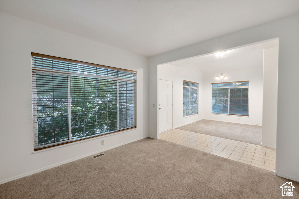 Bright interior space with large windows featuring horizontal blinds