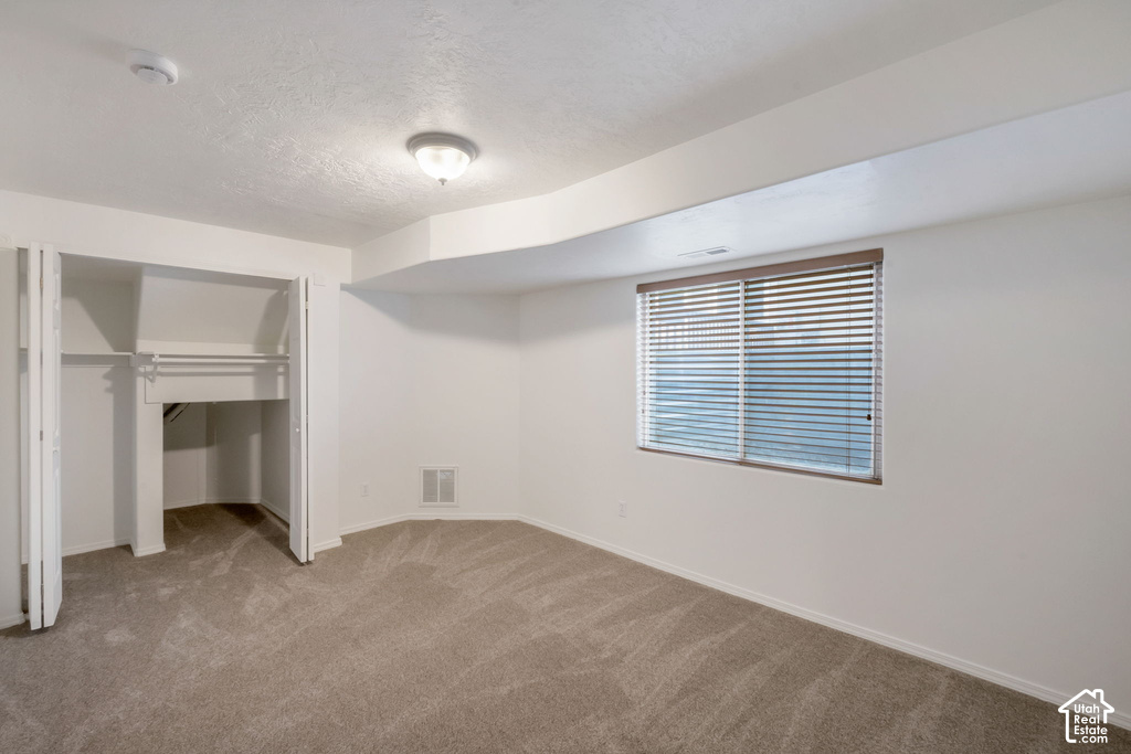 Neutral-toned carpeting and light-colored walls define this room