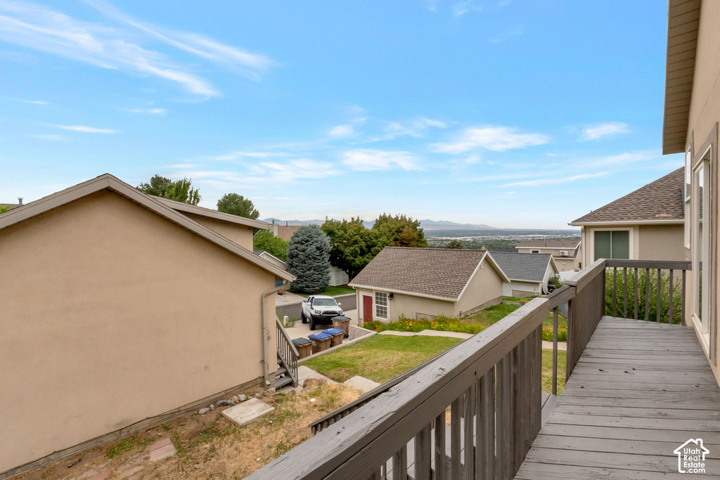 Elevated wood-plank deck with wood railing, offering expansive distant scenery