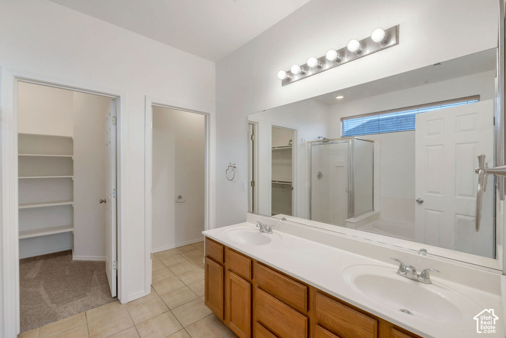 Double vanity with white countertops and wood cabinetry