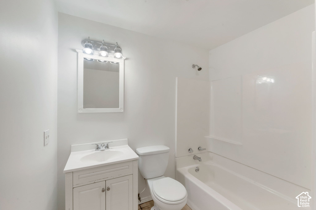 Bathroom featuring white walls and a white bathtub with shower