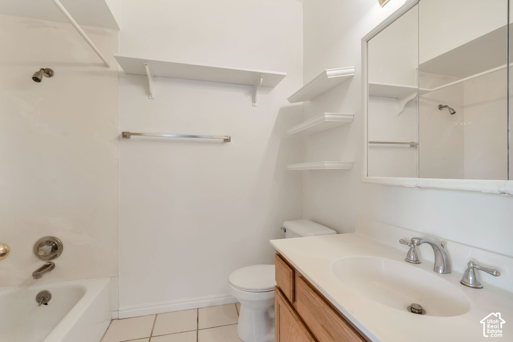 Bathroom featuring a light-toned vanity with an integrated sink, a mirrored medicine cabinet, and a bathtub with shower fixture
