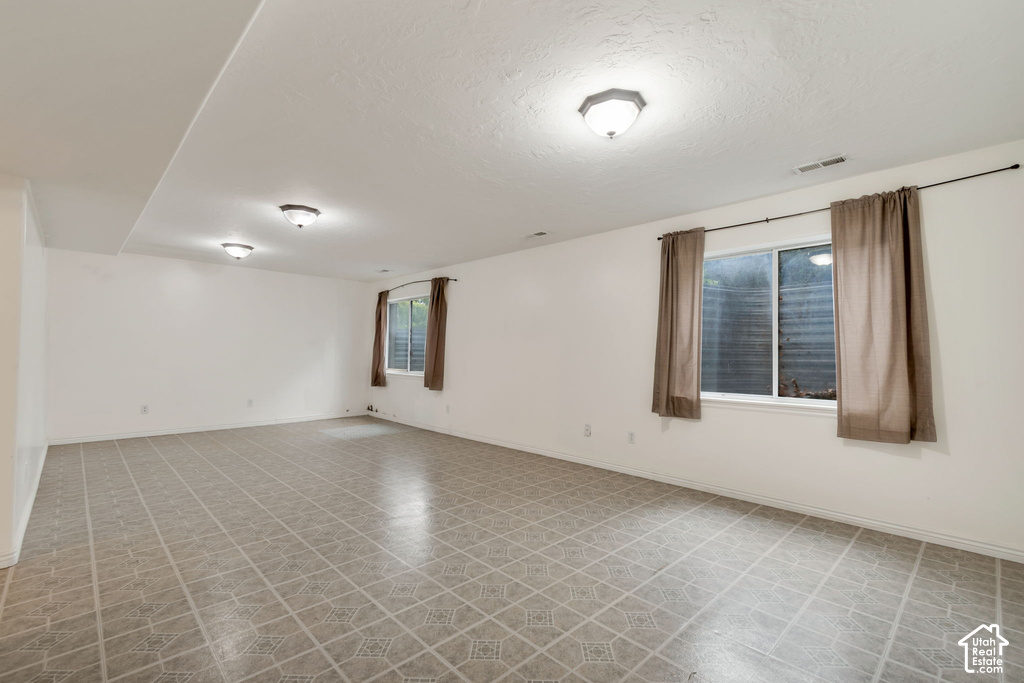 Expansive room featuring patterned tile flooring and white walls